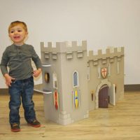 FunDeco Playhouses, boy next to castle