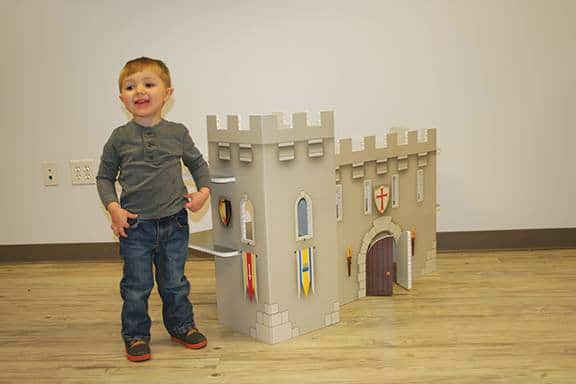 FunDeco Playhouses, boy next to castle