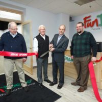 FunDeco Owners clipping Grand Opening ribbon in office