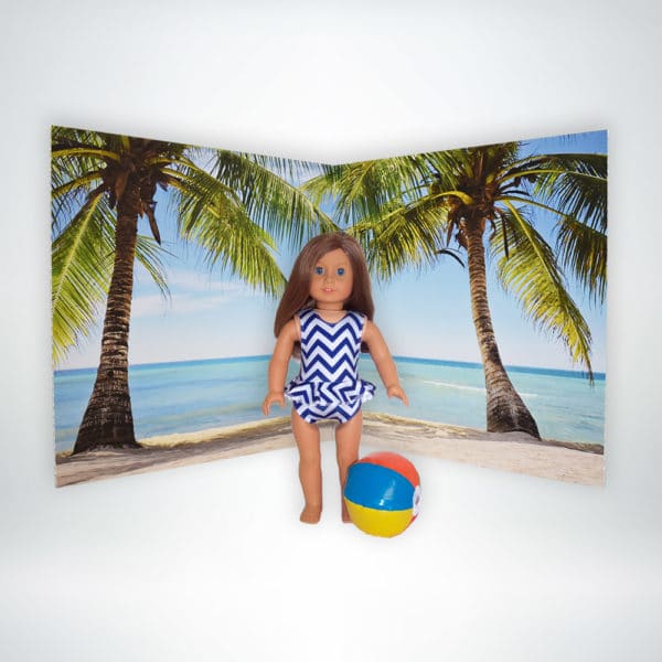 FunDeco Scenic Doll Backdrop beach scene with doll in suit and beach ball
